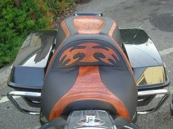 A black and orange motorcycle with flames on the seat