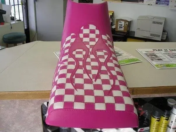 A pink and white checkered item is sitting on a table