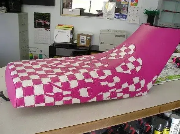 A pink and white checkered seat is sitting on a table