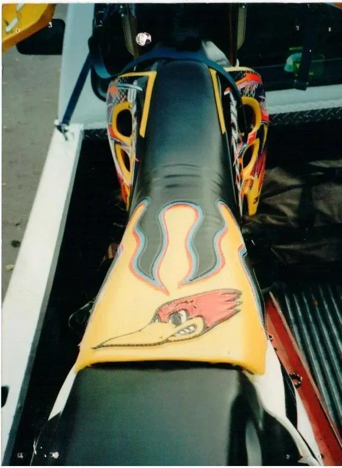 A motorcycle with a woody woodpecker on the seat