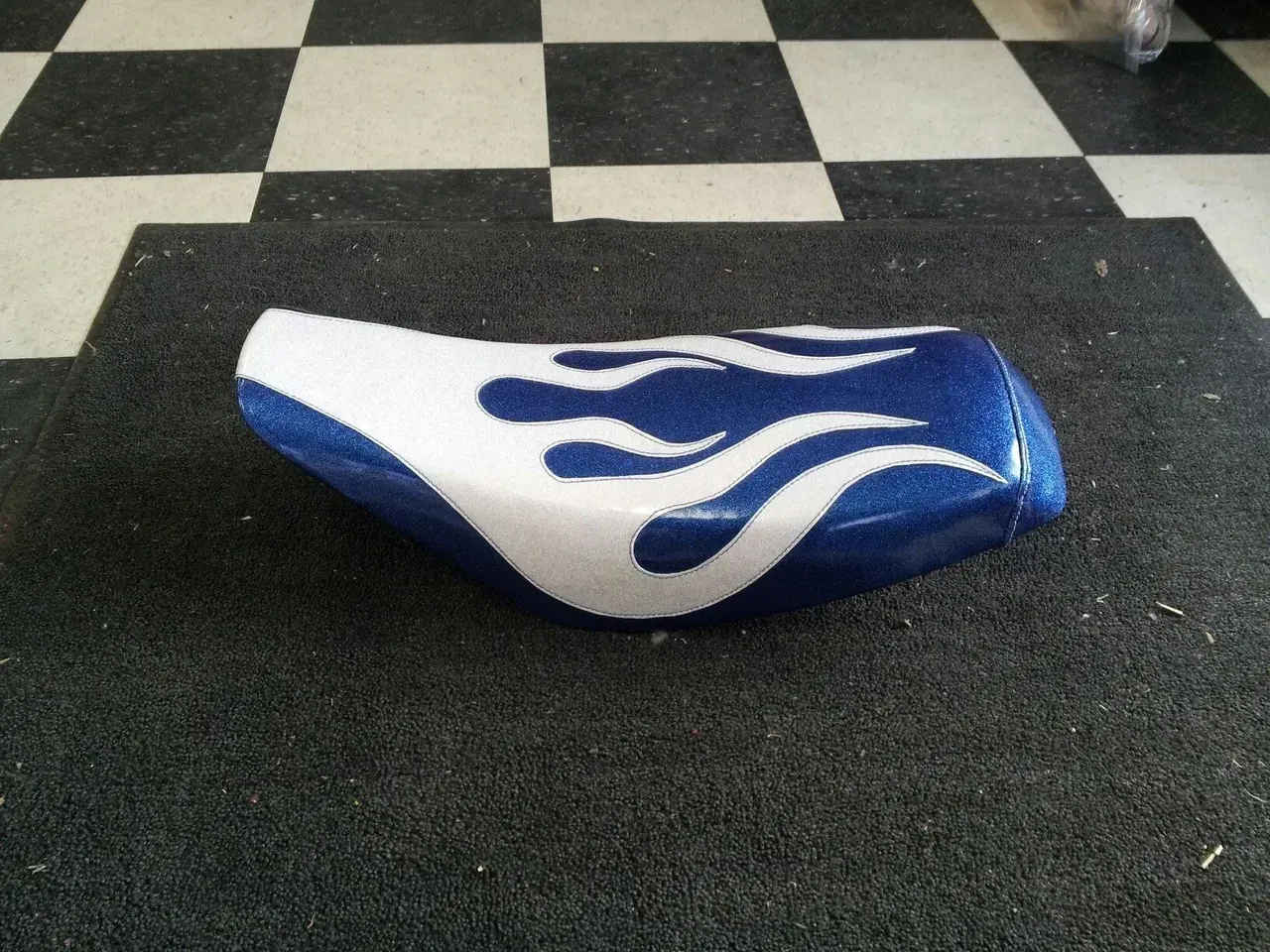 A blue and white seat with flames painted on it