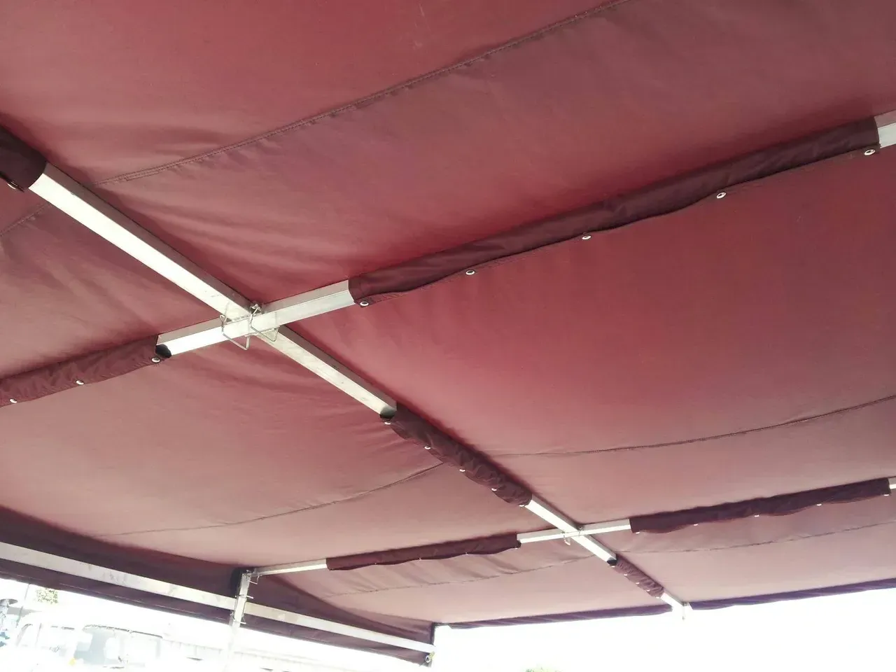 A close up of a red umbrella with a white frame.