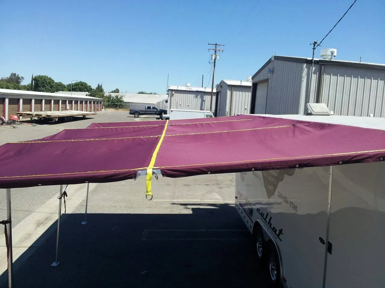 A trailer with a purple awning on top of it