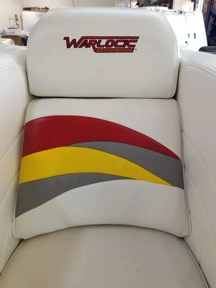 A white chair with a warlock logo on it