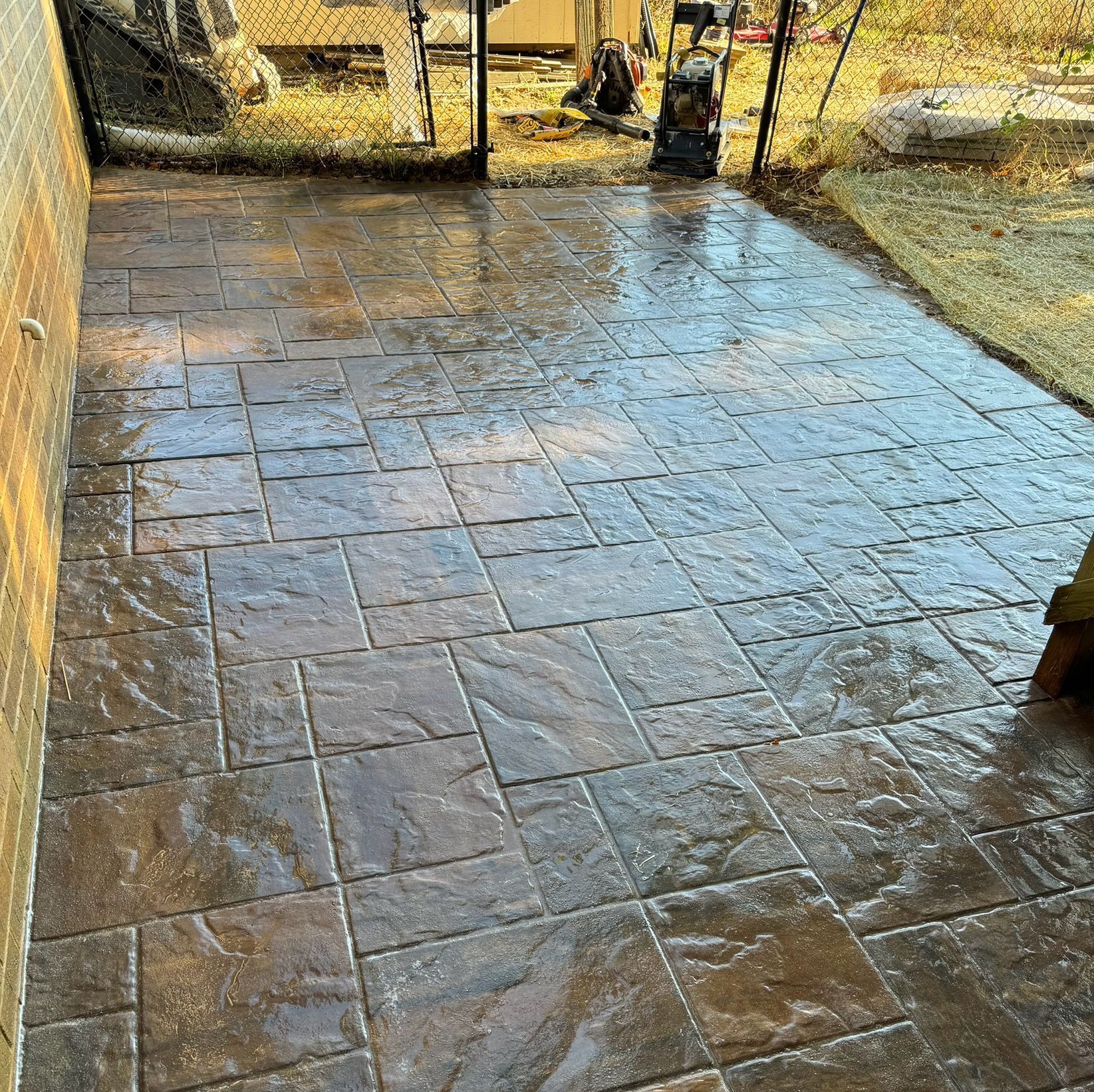 A patio with a concrete floor and a vacuum cleaner on it.