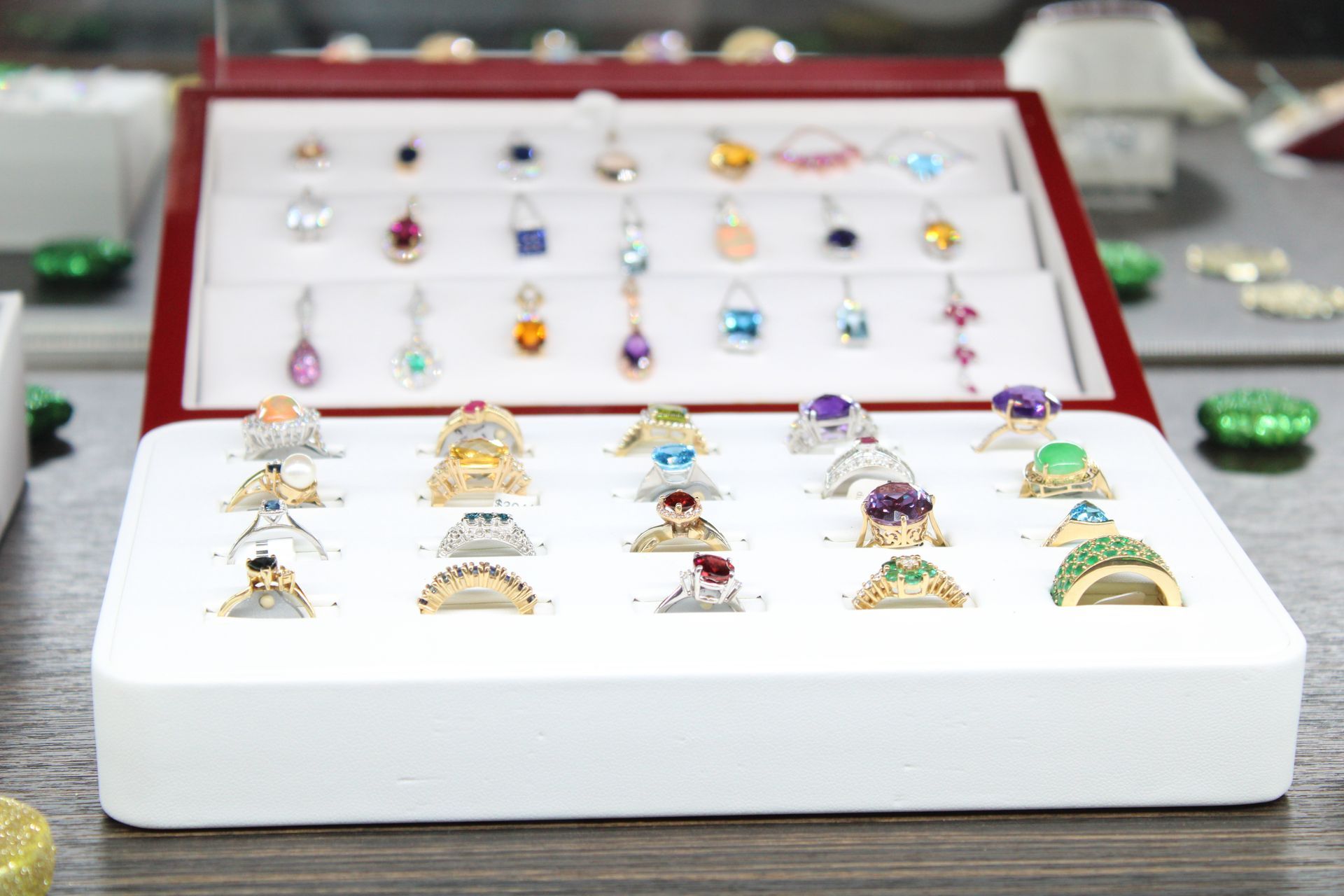 a display case filled with lots of rings on a table .