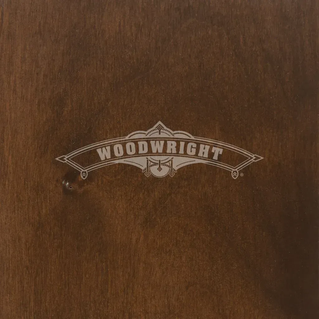 Woodwright logo in silver on a dark brown wooden surface.