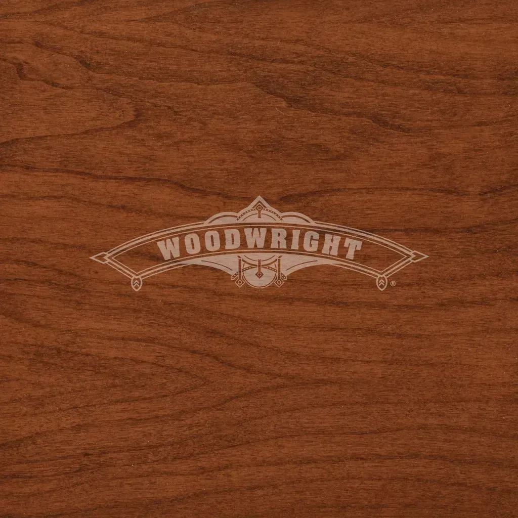 Logo for Woodwright furniture on a woodgrain background.