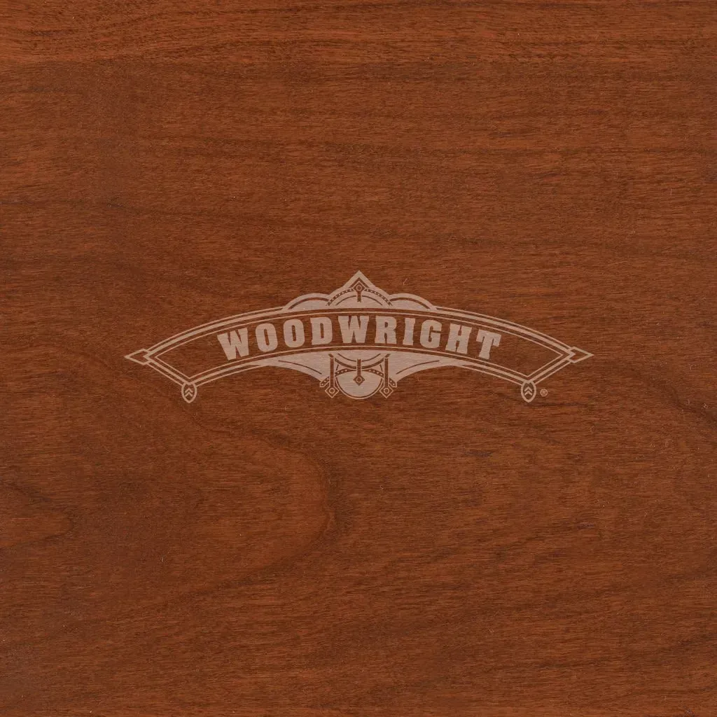 Woodwright logo on a dark reddish-brown wooden surface.