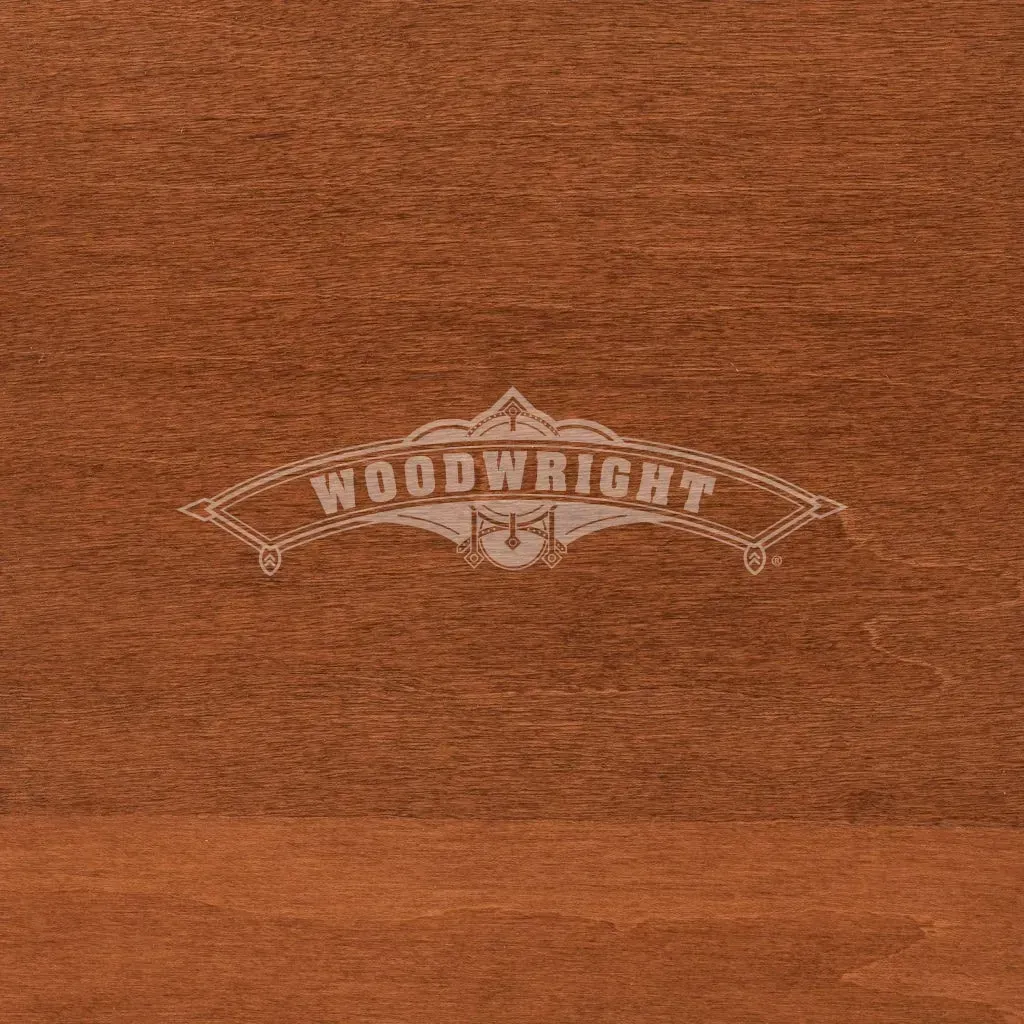 Woodwright logo on brown wood surface.