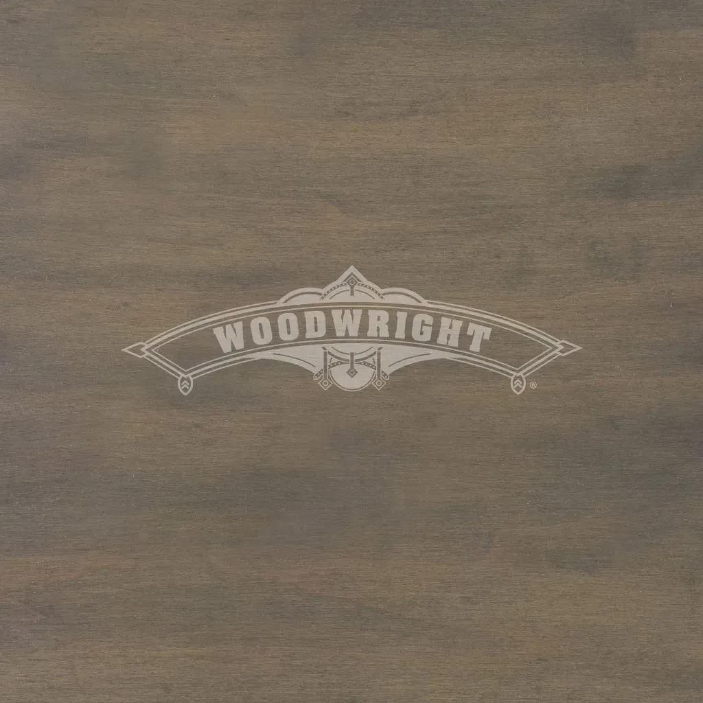 Woodwright logo on a brown wood surface.