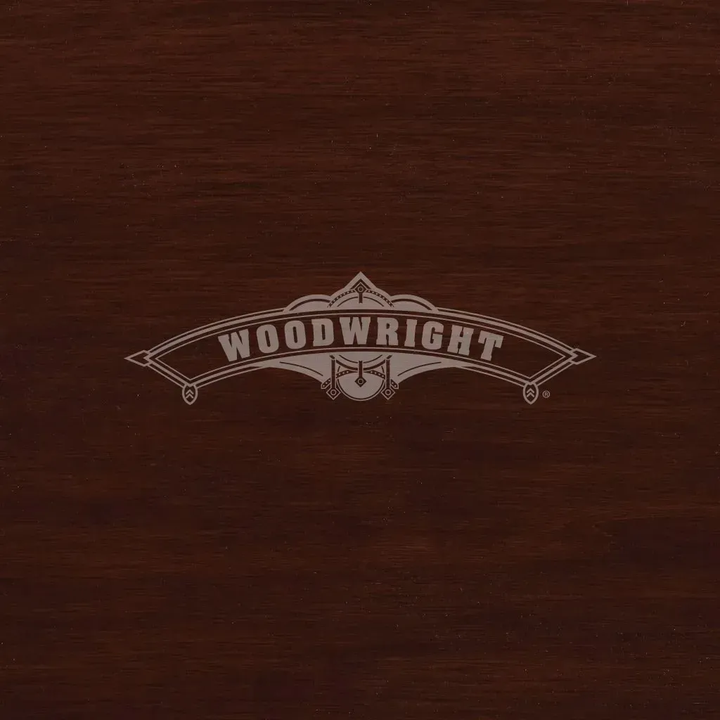 Woodwright logo in silver on a dark brown wood background.