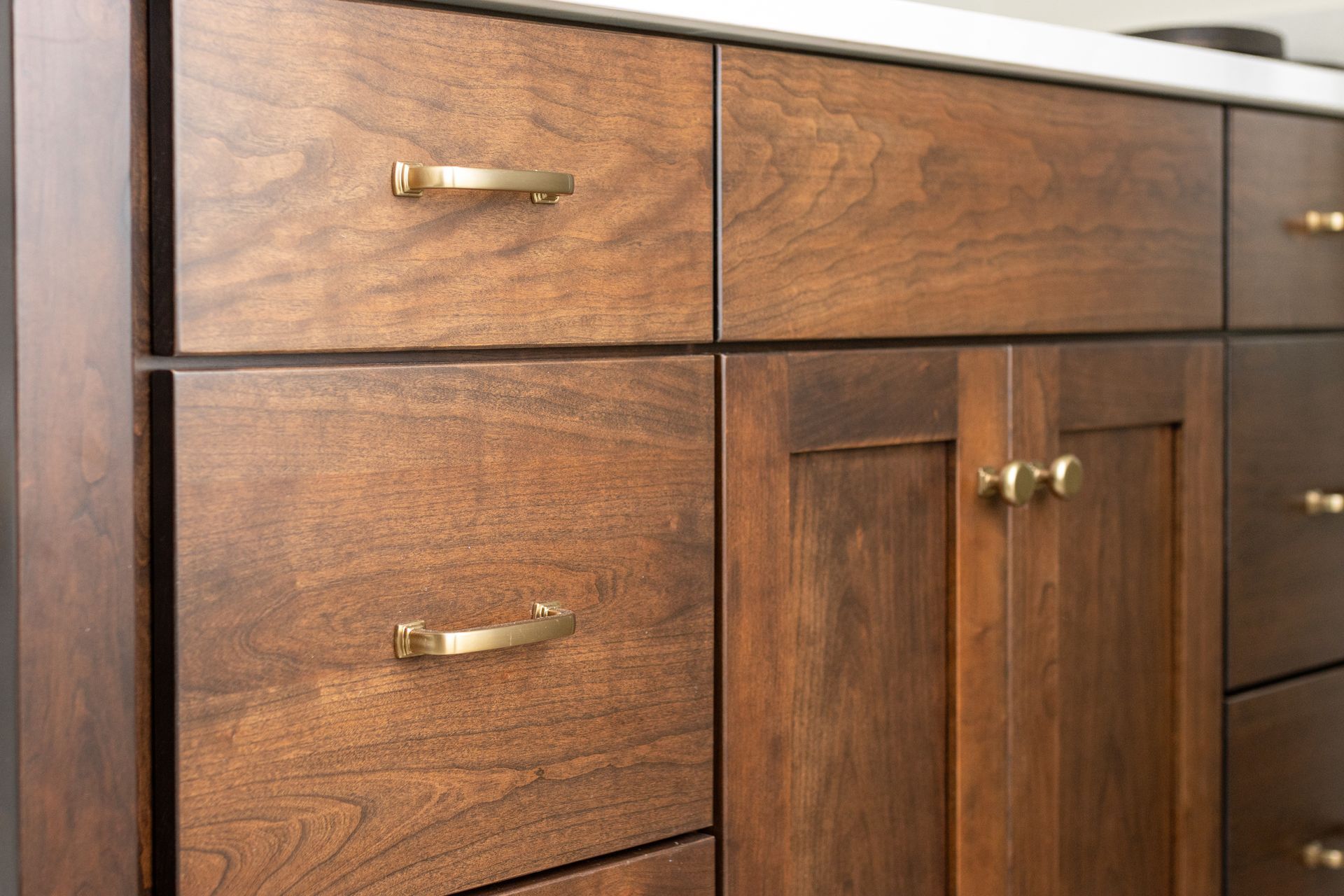 Wooden bathroom vanity with brass hardware.