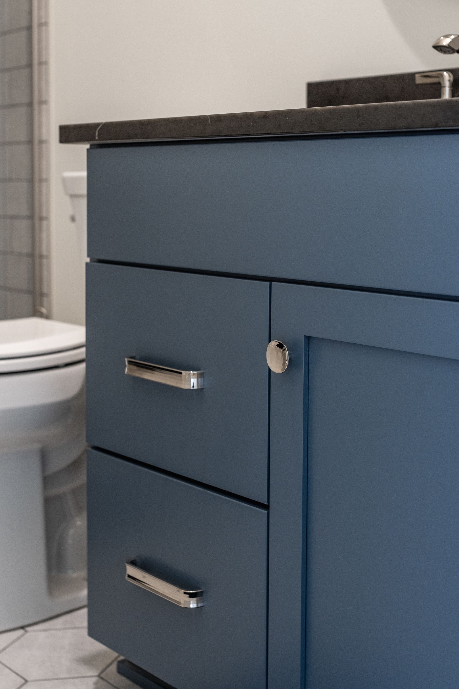 Blue bathroom vanity with silver hardware.
