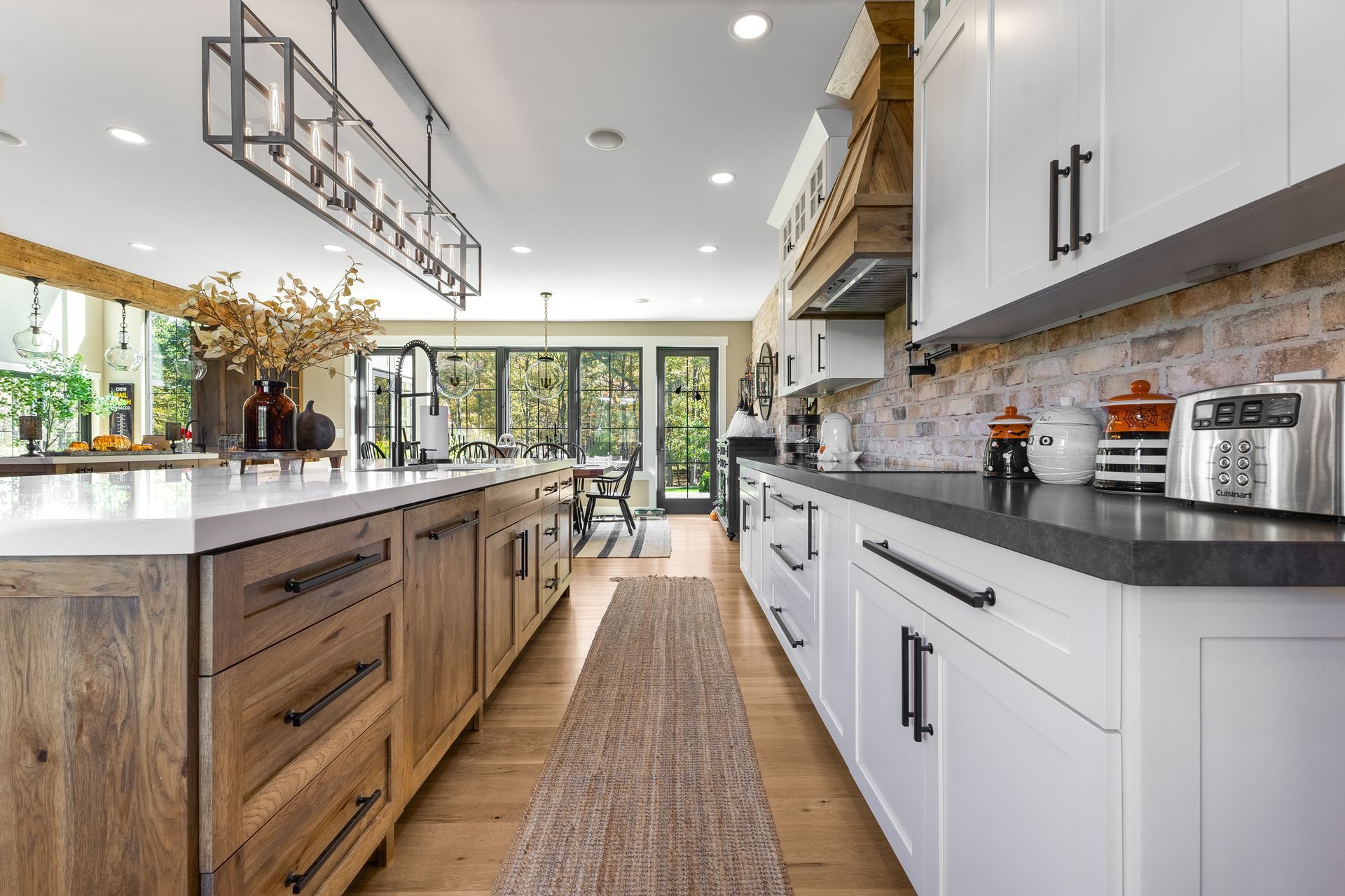 Spacious kitchen with wood cabinets, white countertops, and brick backsplash; view of dining area.