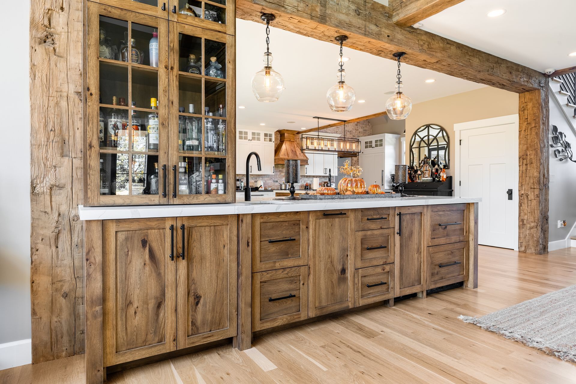 Rustic wooden kitchen island with a built-in bar and glass-front cabinet.