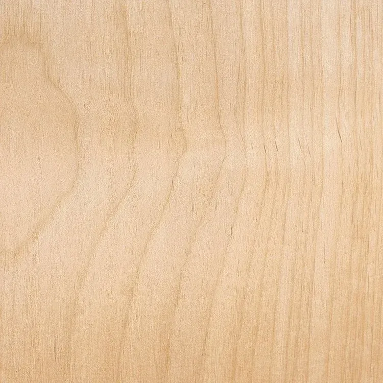 Close-up of a light-colored wood grain surface with visible swirling patterns and vertical lines.