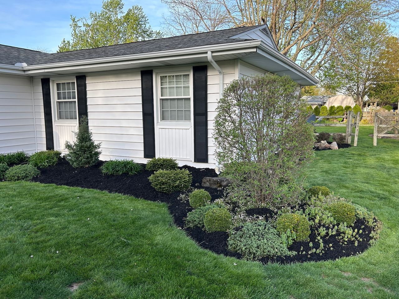 White house and landscaped garden bed.