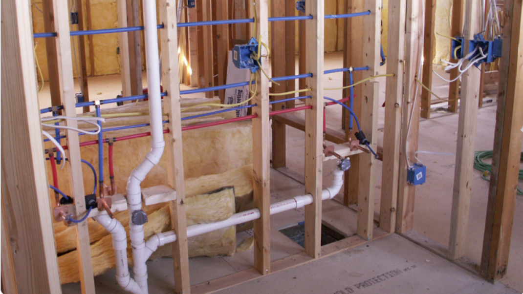 plumber maintaining plumbing system in retail store
