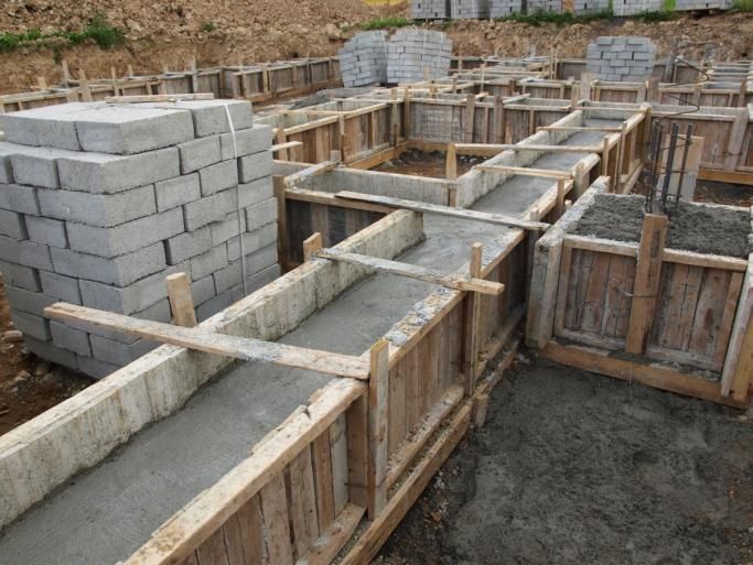 A construction site with concrete blocks and wooden forms