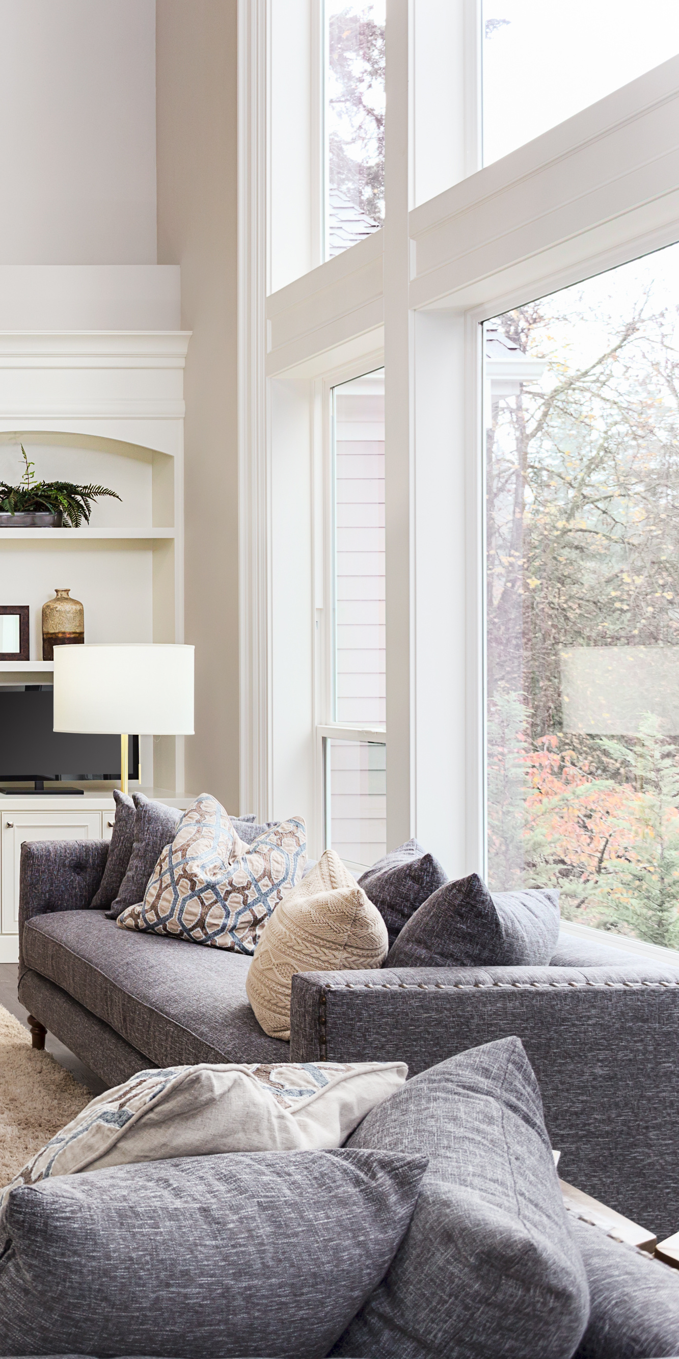 A living room filled with furniture and a large window.