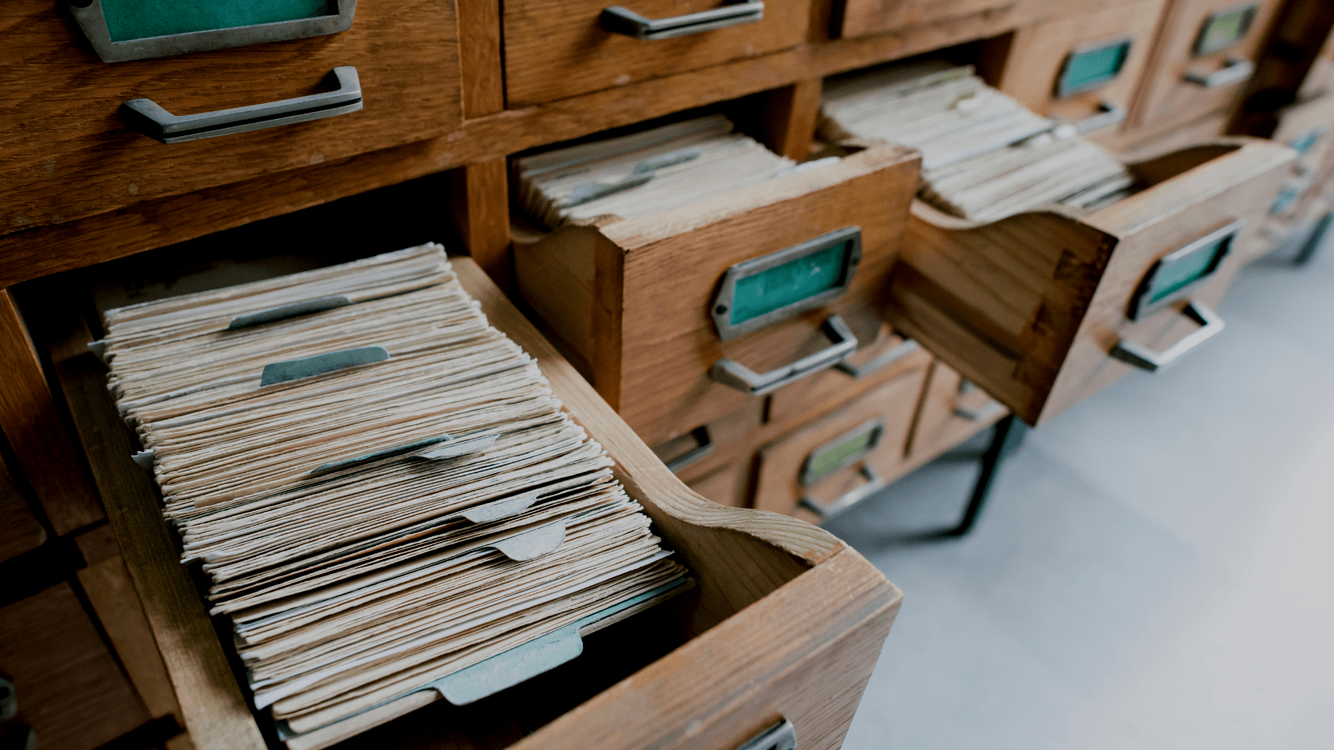 A stack of cards is sitting in a wooden drawer.