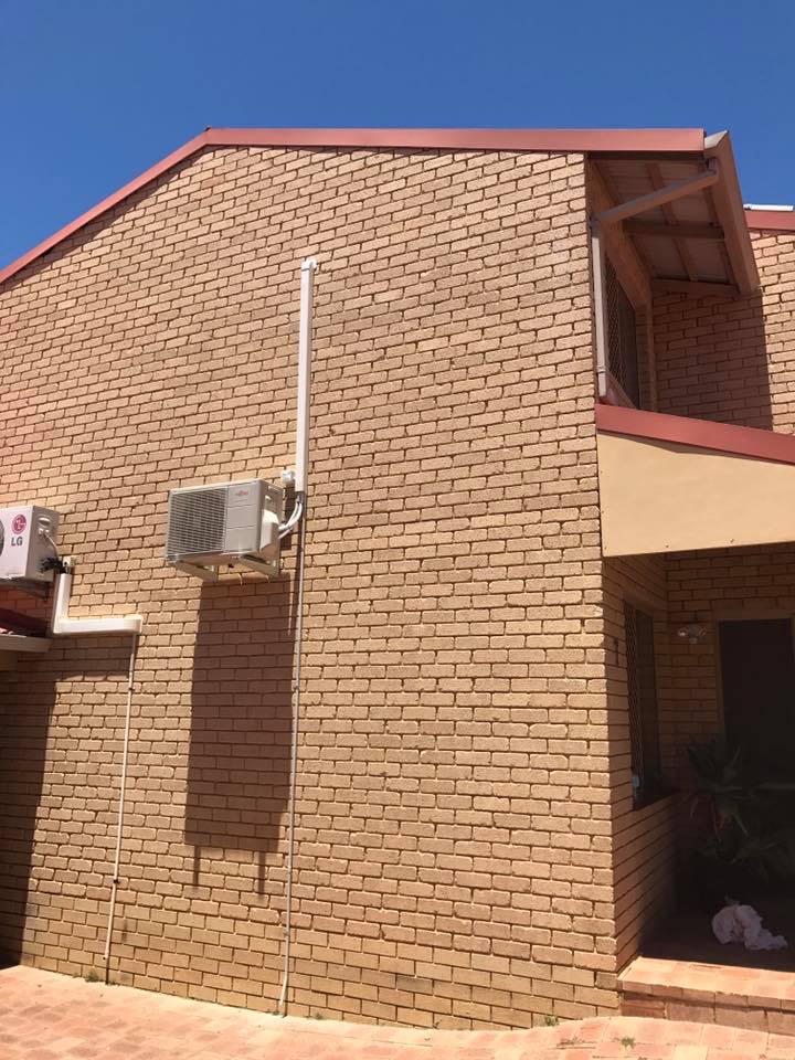 Out side unit of a split system air conditioner unit mounted on the outside of a building in Perth, WA
