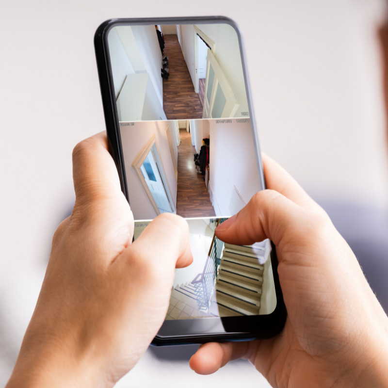 Smartphone app connected to cctv and checking on the house