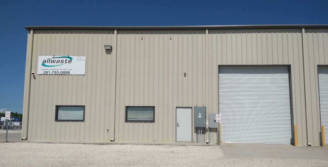 A building in Baytown, Texas with a sign on the side that says Allwaste Industrial Services, LLC