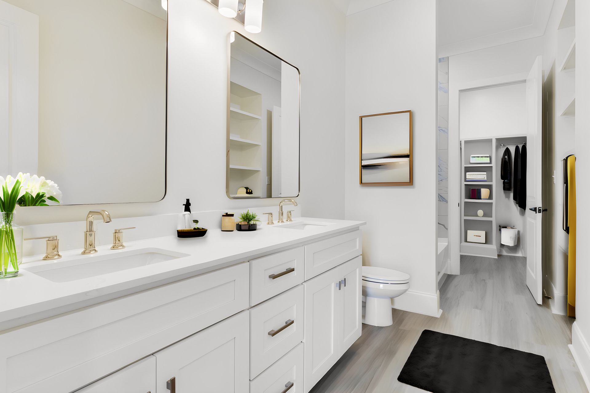 A bathroom with two sinks , a toilet , and a walk in closet.