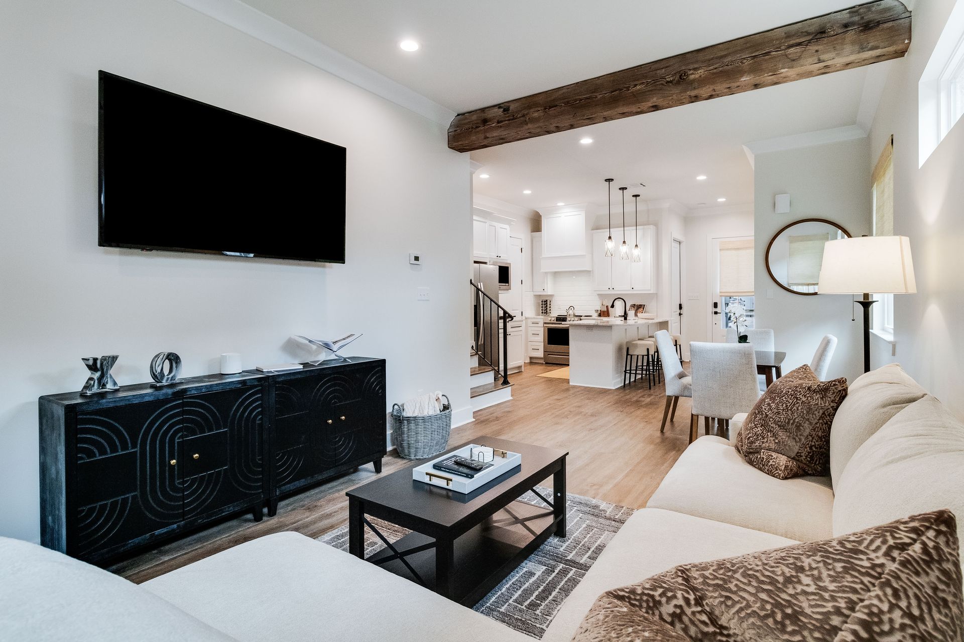 A living room with a couch , coffee table , and flat screen tv.