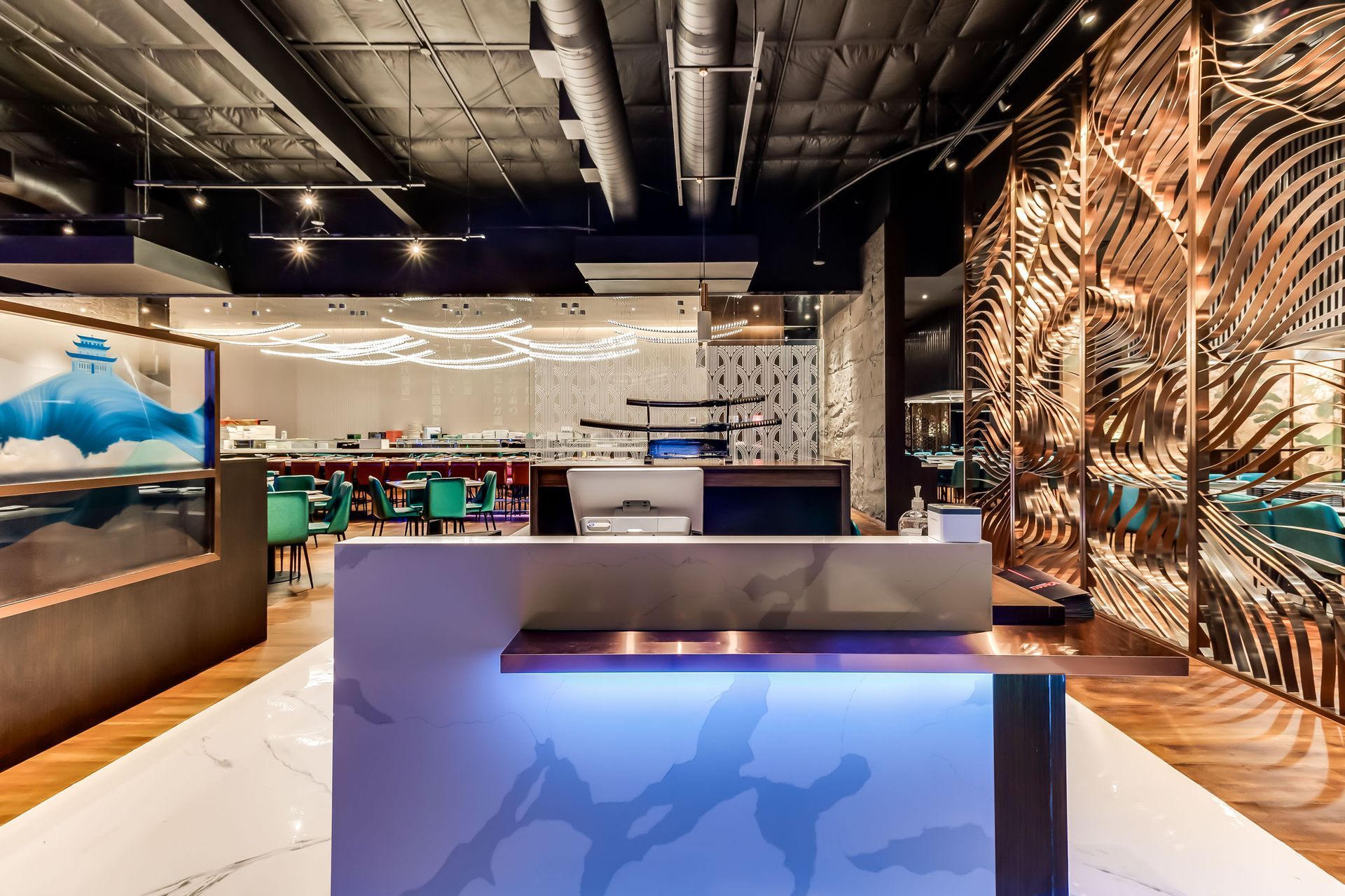 A reception desk in a restaurant with a blue light on it.