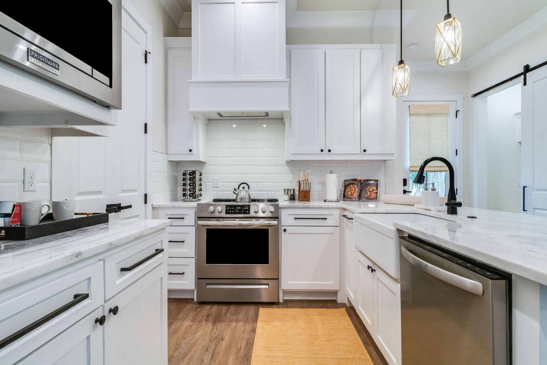 A kitchen with white cabinets and stainless steel appliances.