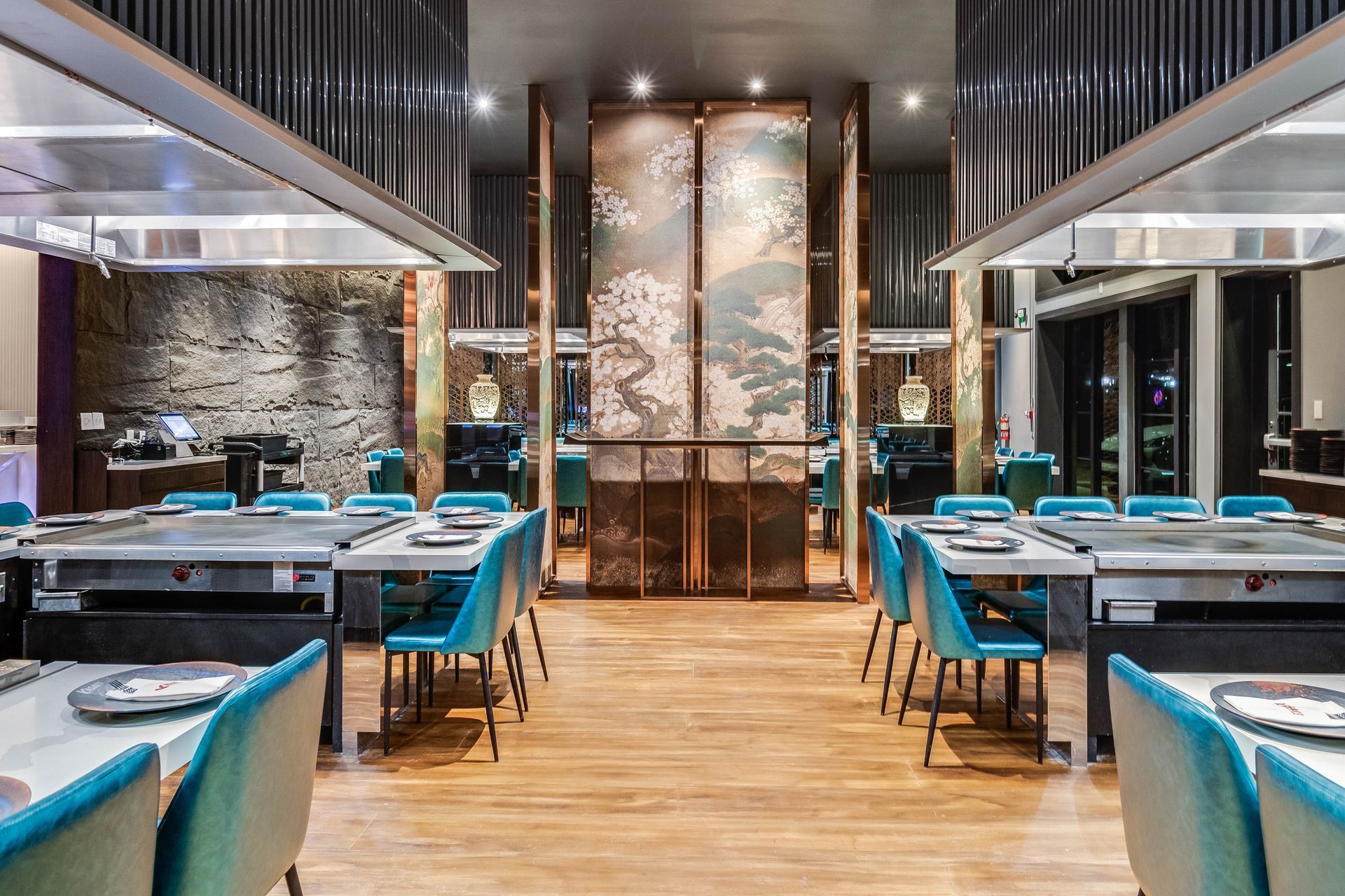 A large dining room with tables and chairs in a restaurant.