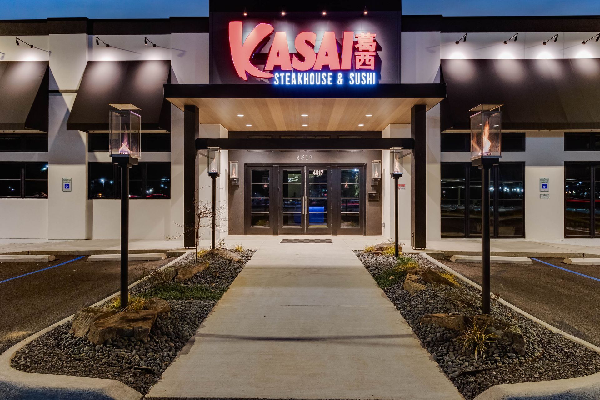 The entrance to a restaurant called kasai steakhouse and sushi