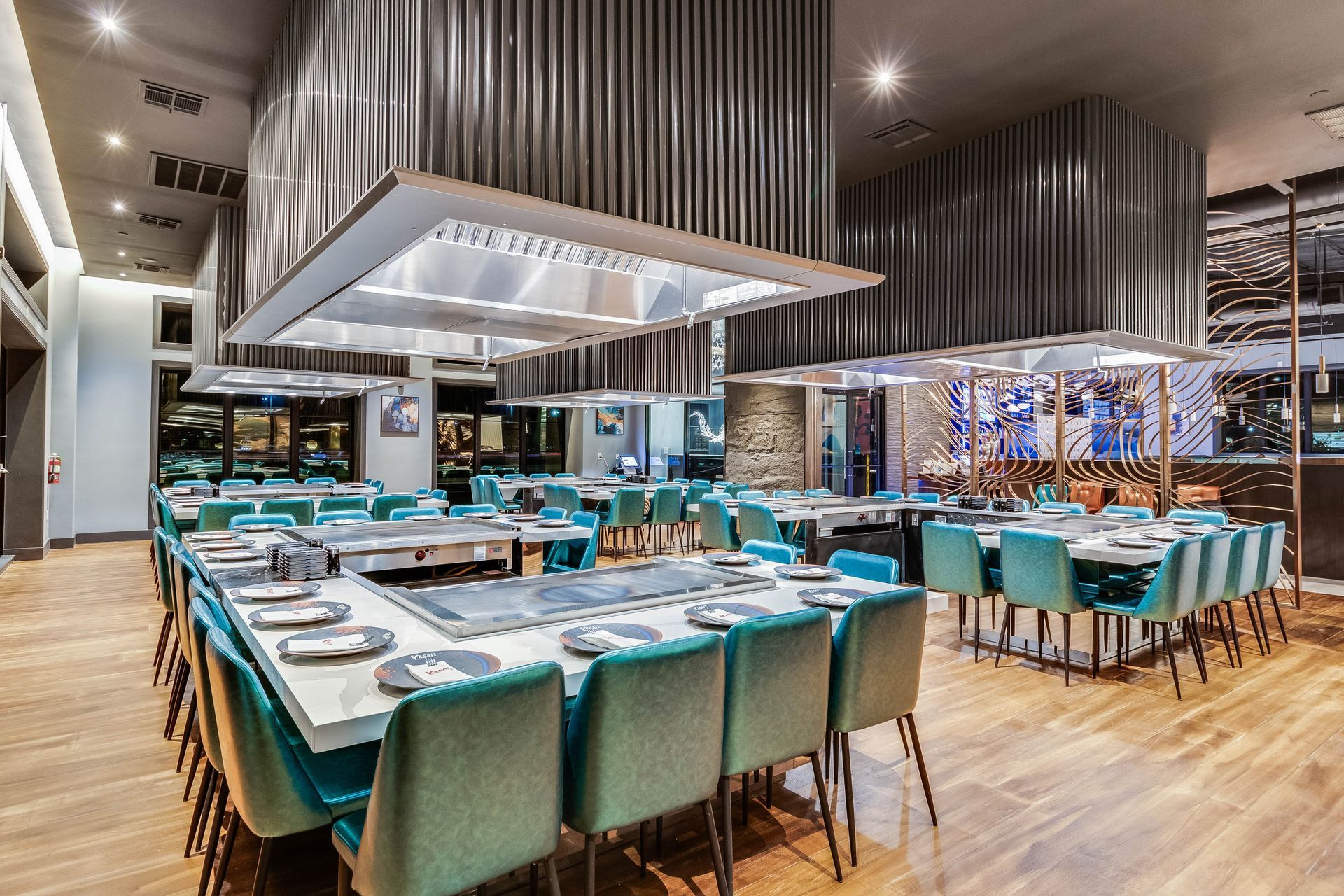 A large dining room with tables and chairs in a restaurant.
