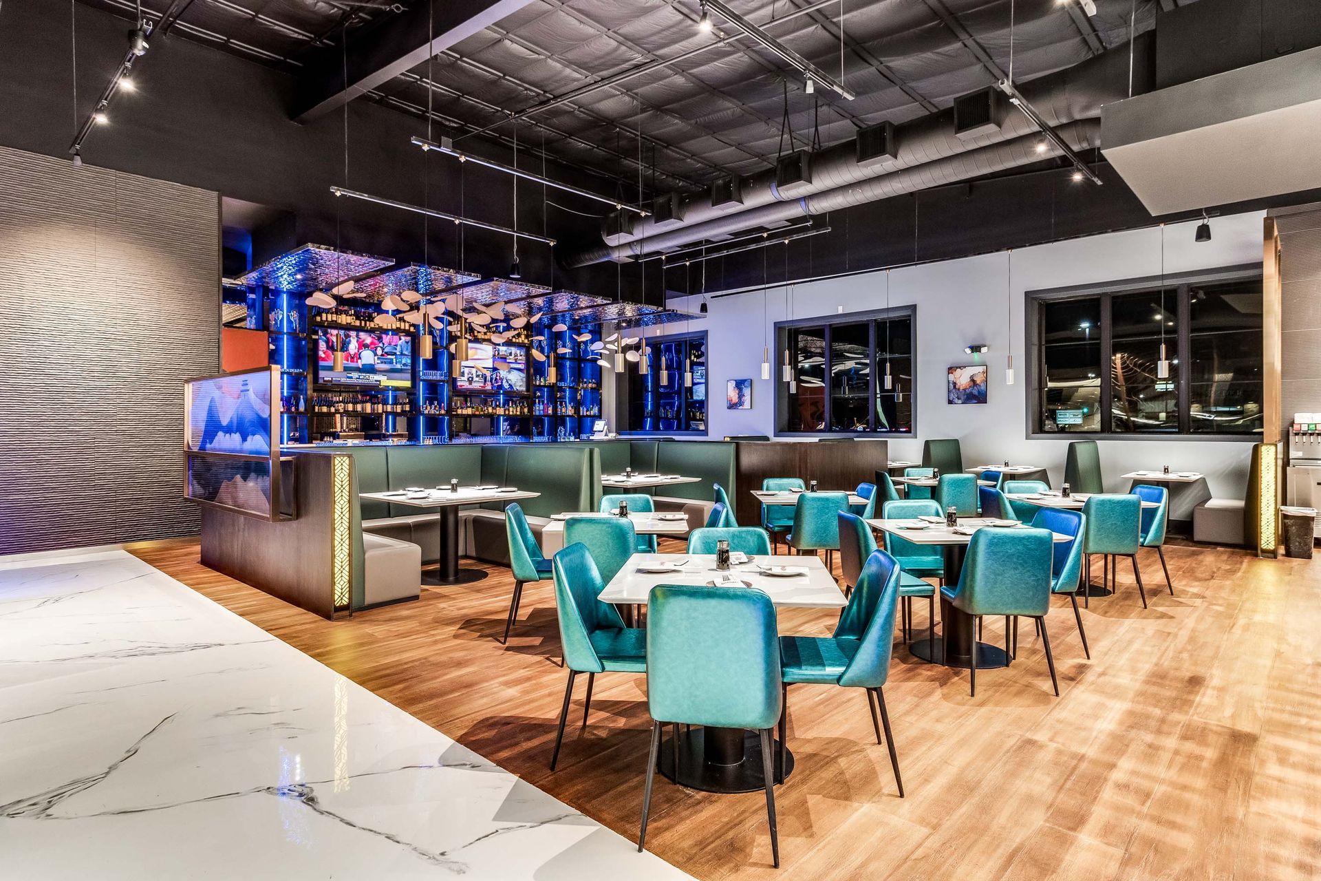A large dining room with tables and chairs in a restaurant.