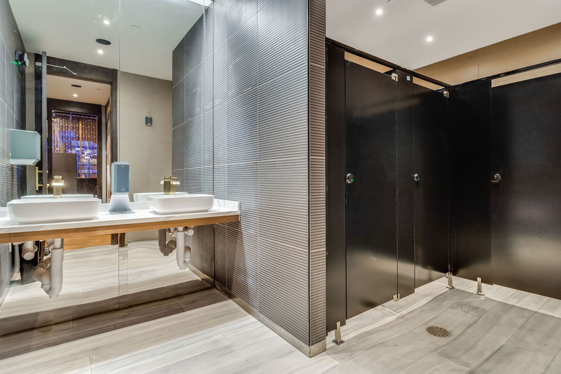 A bathroom with two sinks and a large mirror.