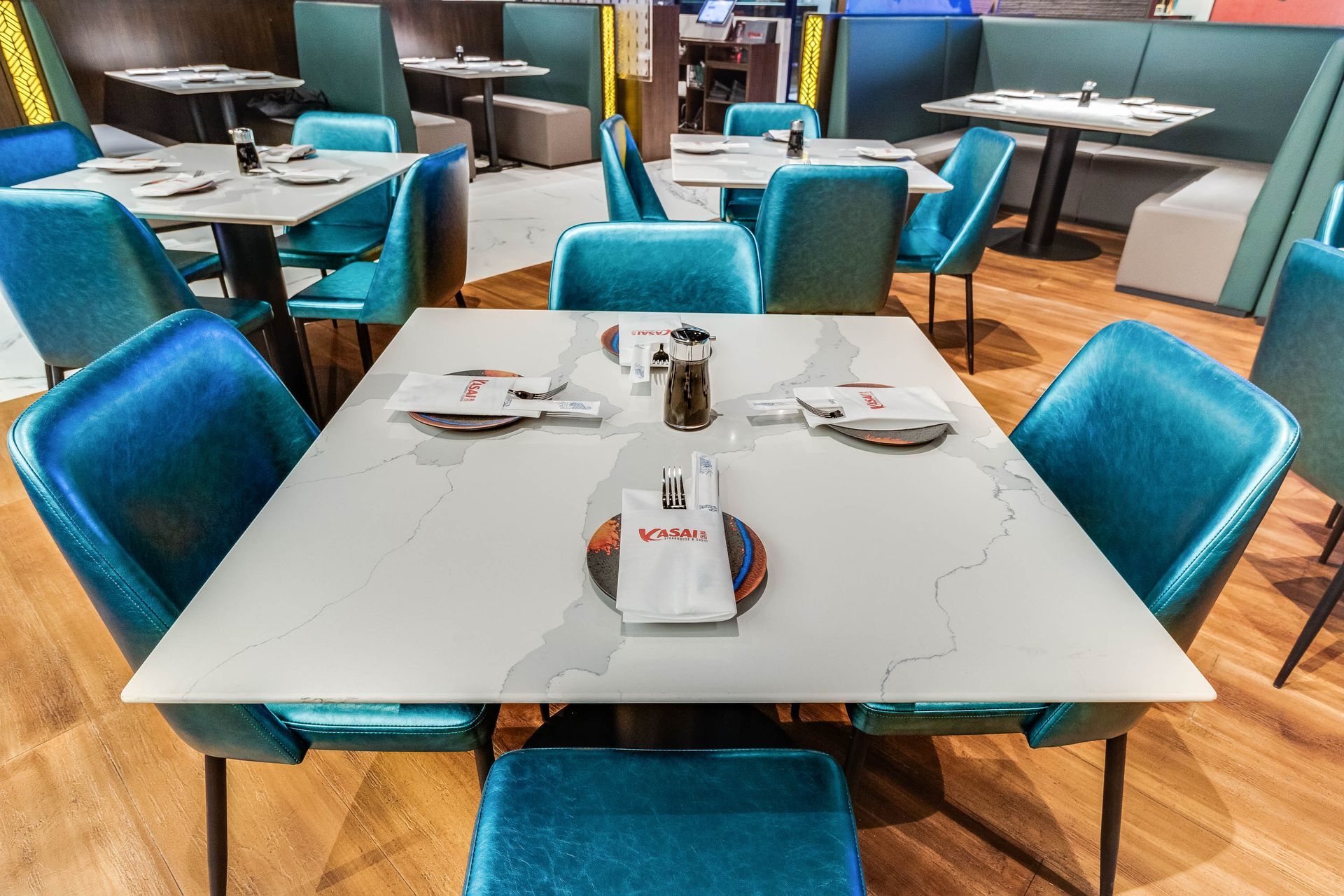 There are many tables and chairs in the restaurant.