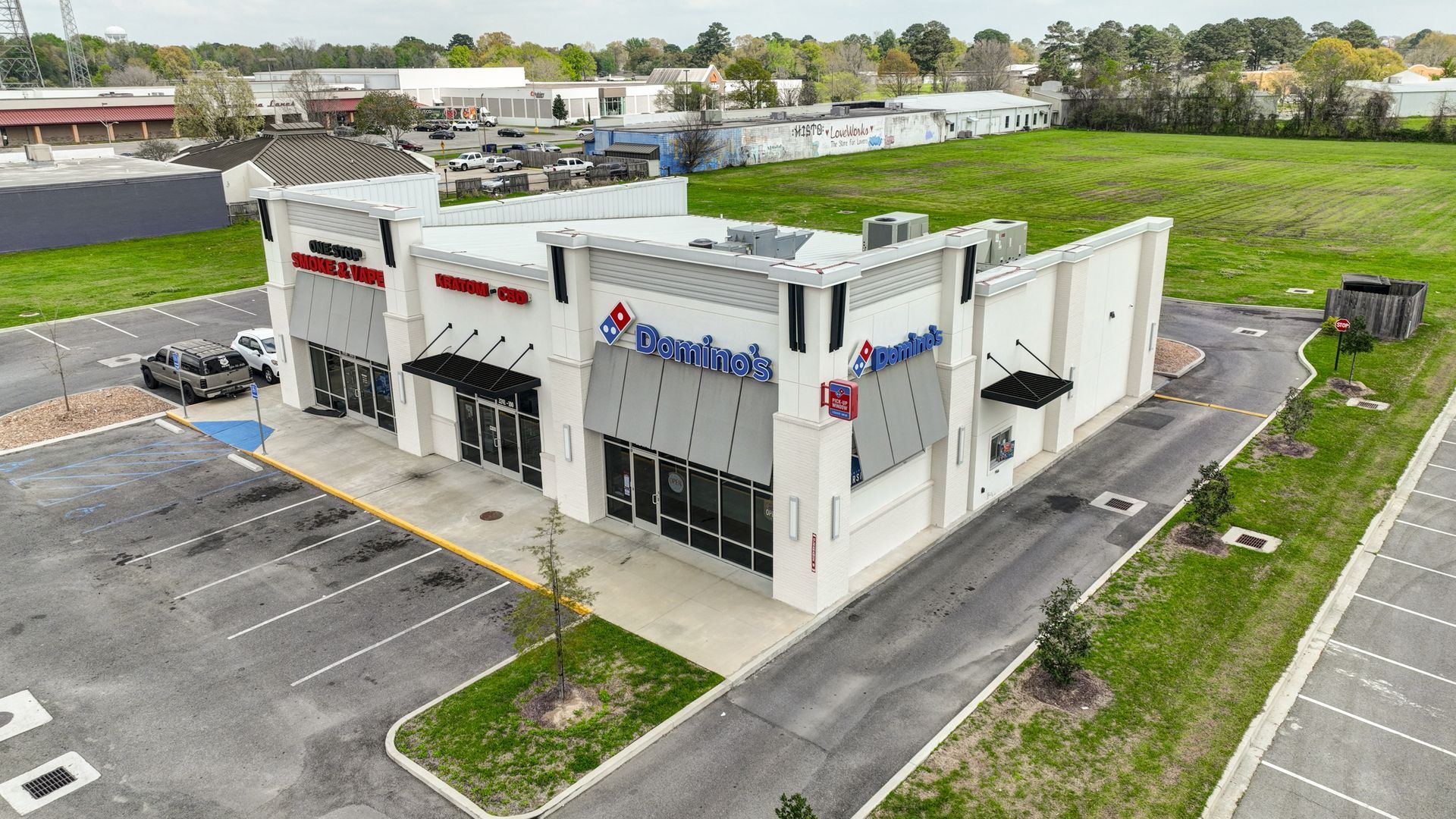 An aerial view of a domino 's pizza restaurant in a parking lot.