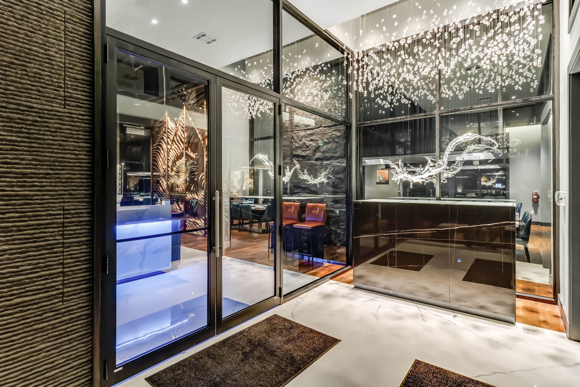 A large room with a lot of windows and a chandelier hanging from the ceiling.