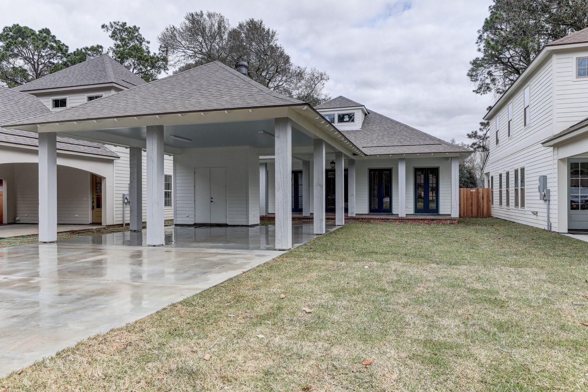 A large white house with a large lawn in front of it.