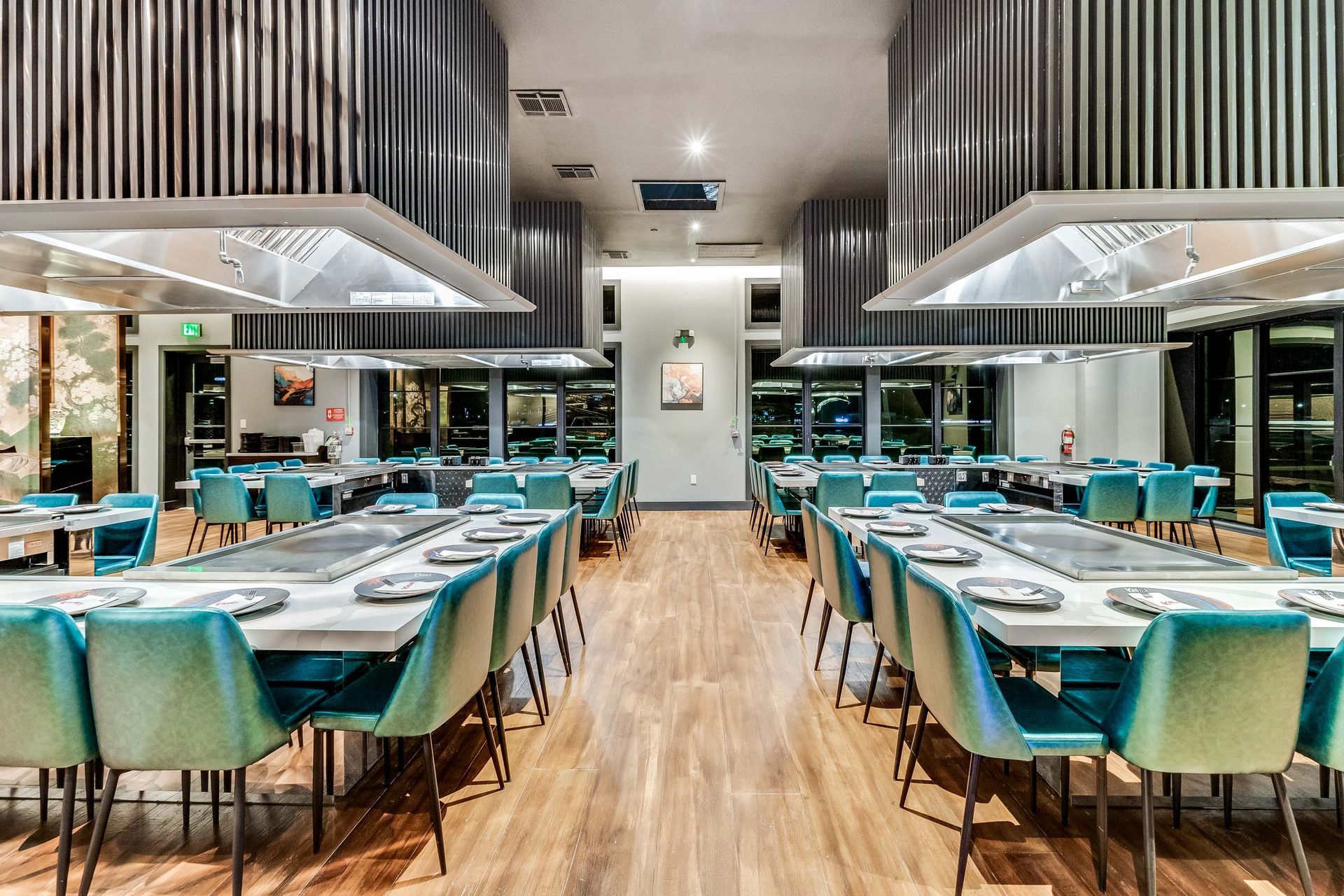 A large dining room with tables and chairs in a restaurant.