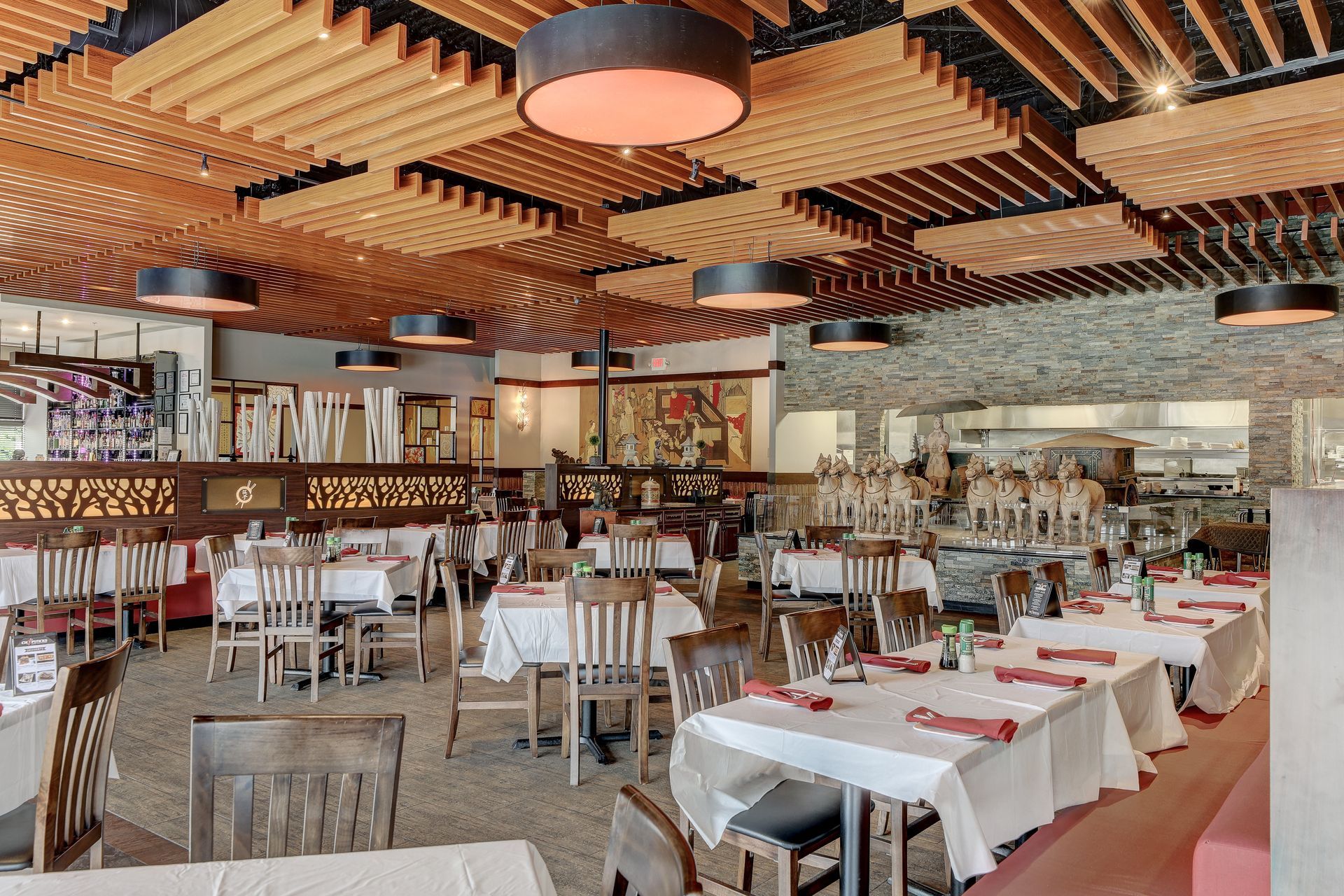 A large dining room with tables and chairs in a restaurant.