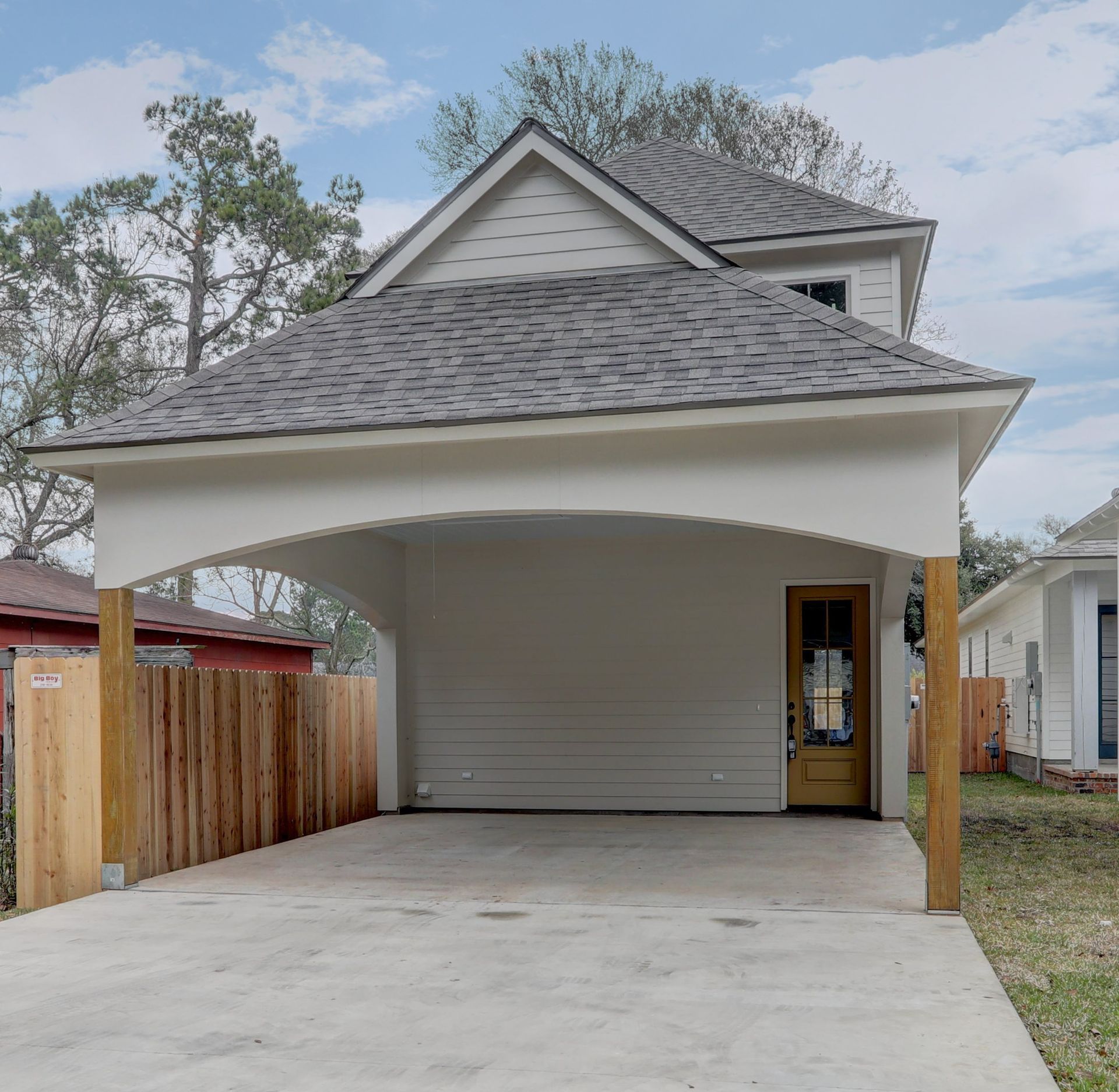 A white house with a carport in front of it