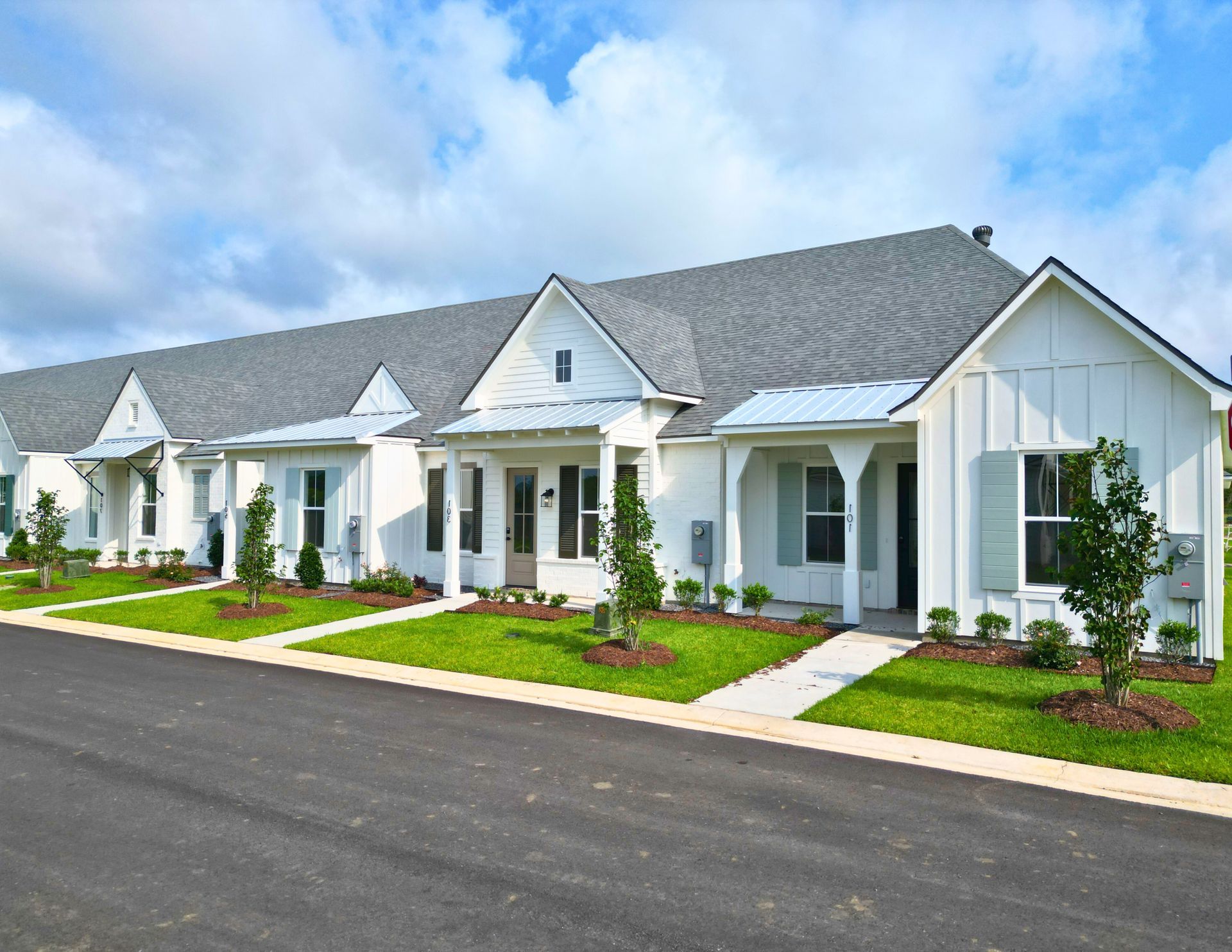 A row of white houses with a gray roof