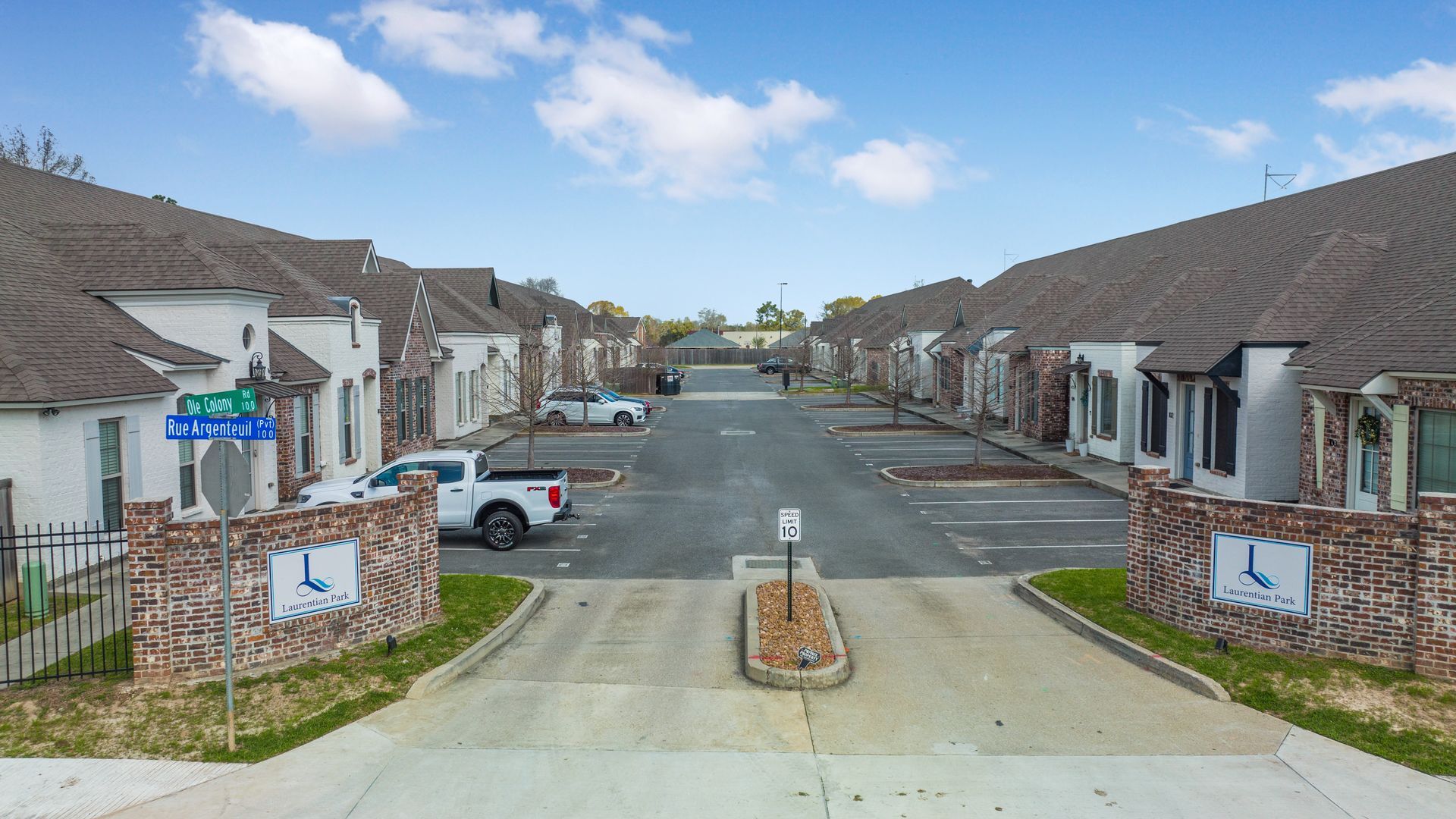 An aerial view of a row of houses and a parking lot.