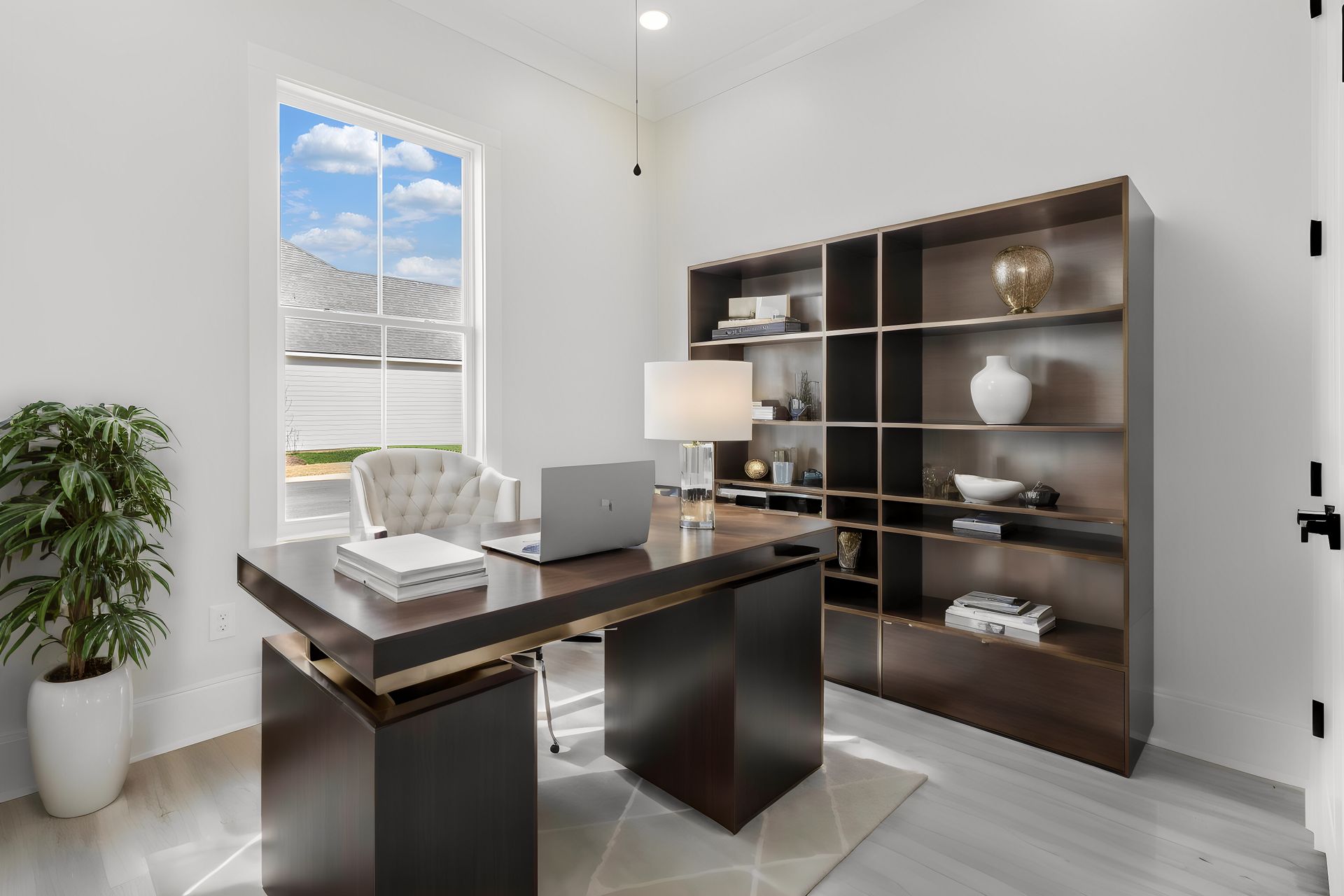 A home office with a desk and a laptop on it.