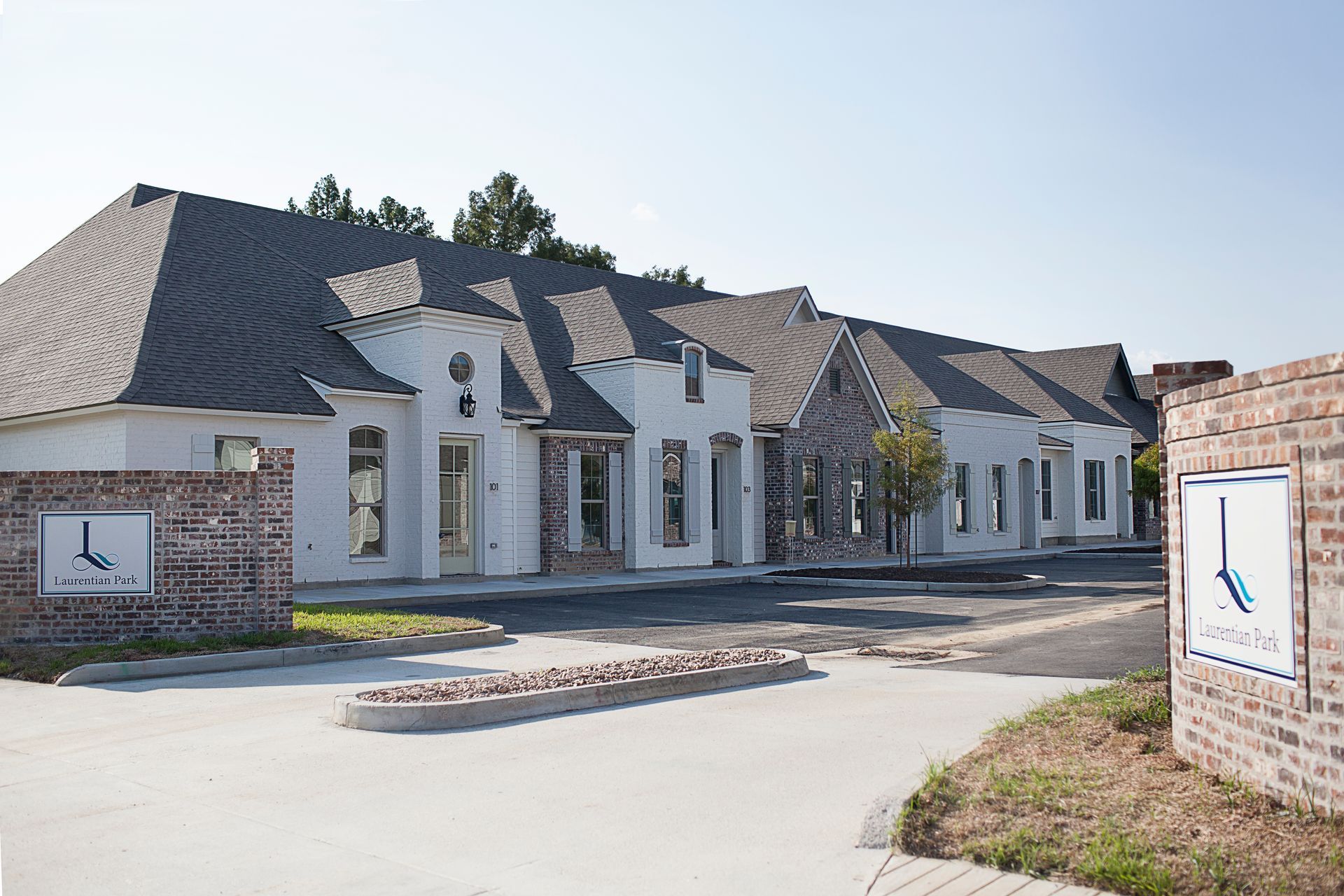 A row of white houses with a sign that says l on it