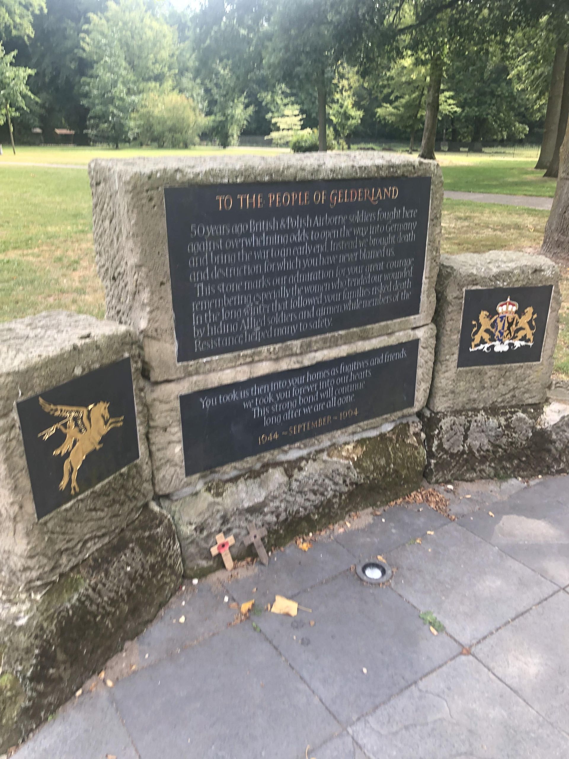 A stone wall with a plaque that says ' memorial ' on it